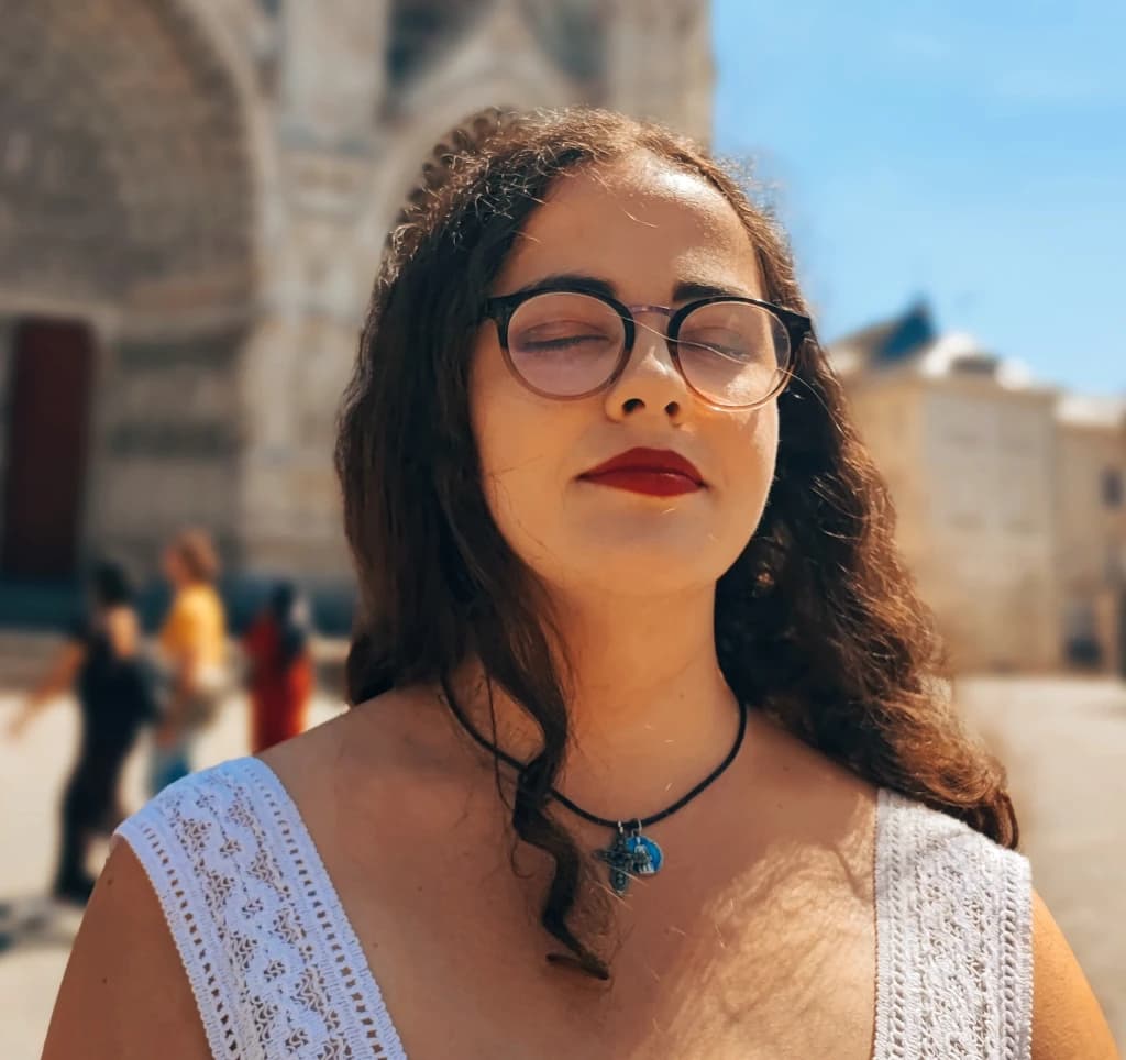 Portrait de Manon Segur en robe blanche devant la cathédrale d'Amiens